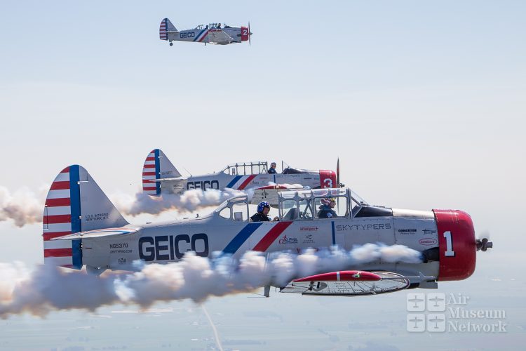 Geico Skytypers with smoke on over Oshkosh at EAA's AirVenture 2018 - photo by David Eckert -Air Museum Network