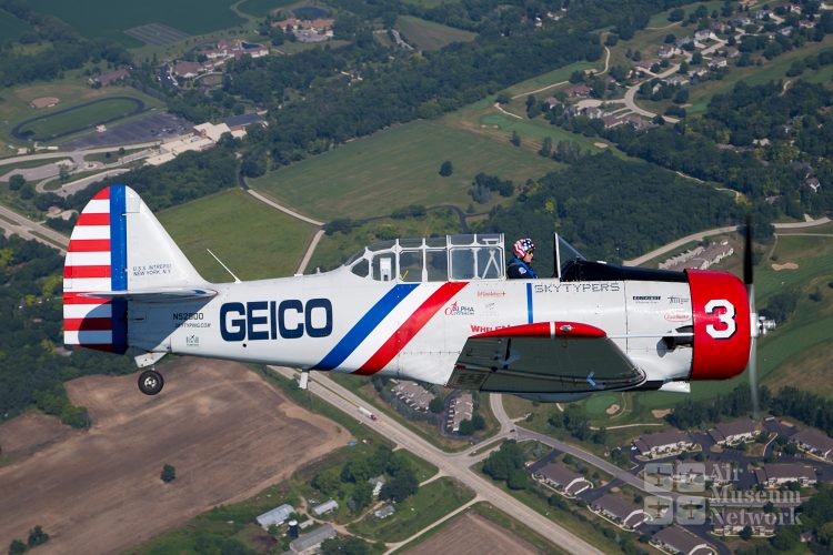 Geico Skytyper #3 profile over Oshkosh at EAA's AirVenture 2018 - photo by David Eckert -Air Museum Network