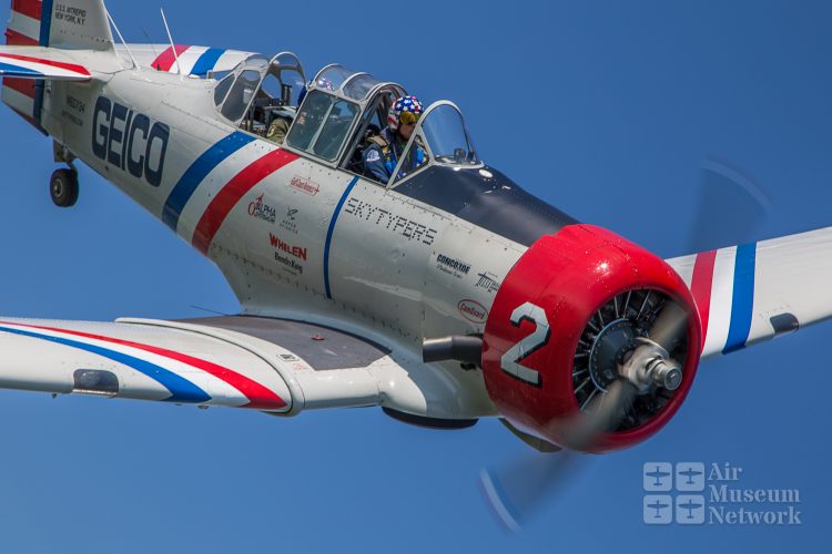 Geico Skytyper #2 in the blue skies over Oshkosh at EAA's AirVenture 2018 - photo by David Eckert -Air Museum Network