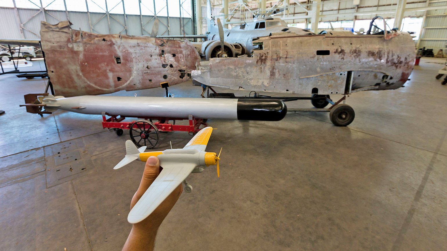 The remains of a Japanese Nakajima B5N Bomber, shown with a World War II torpedo, at the Pacific Aviation Museum Pearl Harbor.