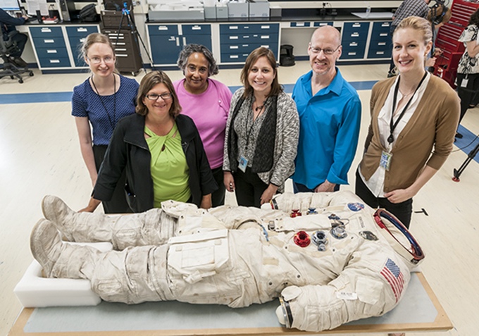 Some of the Smithsonian project team with Armstrong's suit.