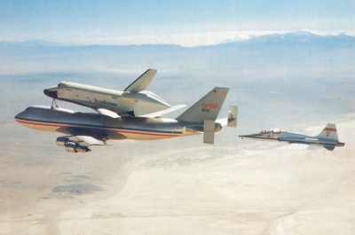 NASA's T-38 jet, tail no. 913, is seen in chase of the Shuttle Carrier Aircraft mated with the orbiter Enterprise in 1977. The same jet will go on display with the prototype shuttle 40 years later. (NASA)